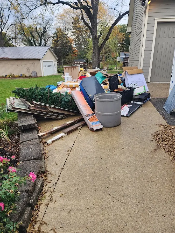 Dumpster being loaded with debris for Residential Dumpster Rental in Freeport